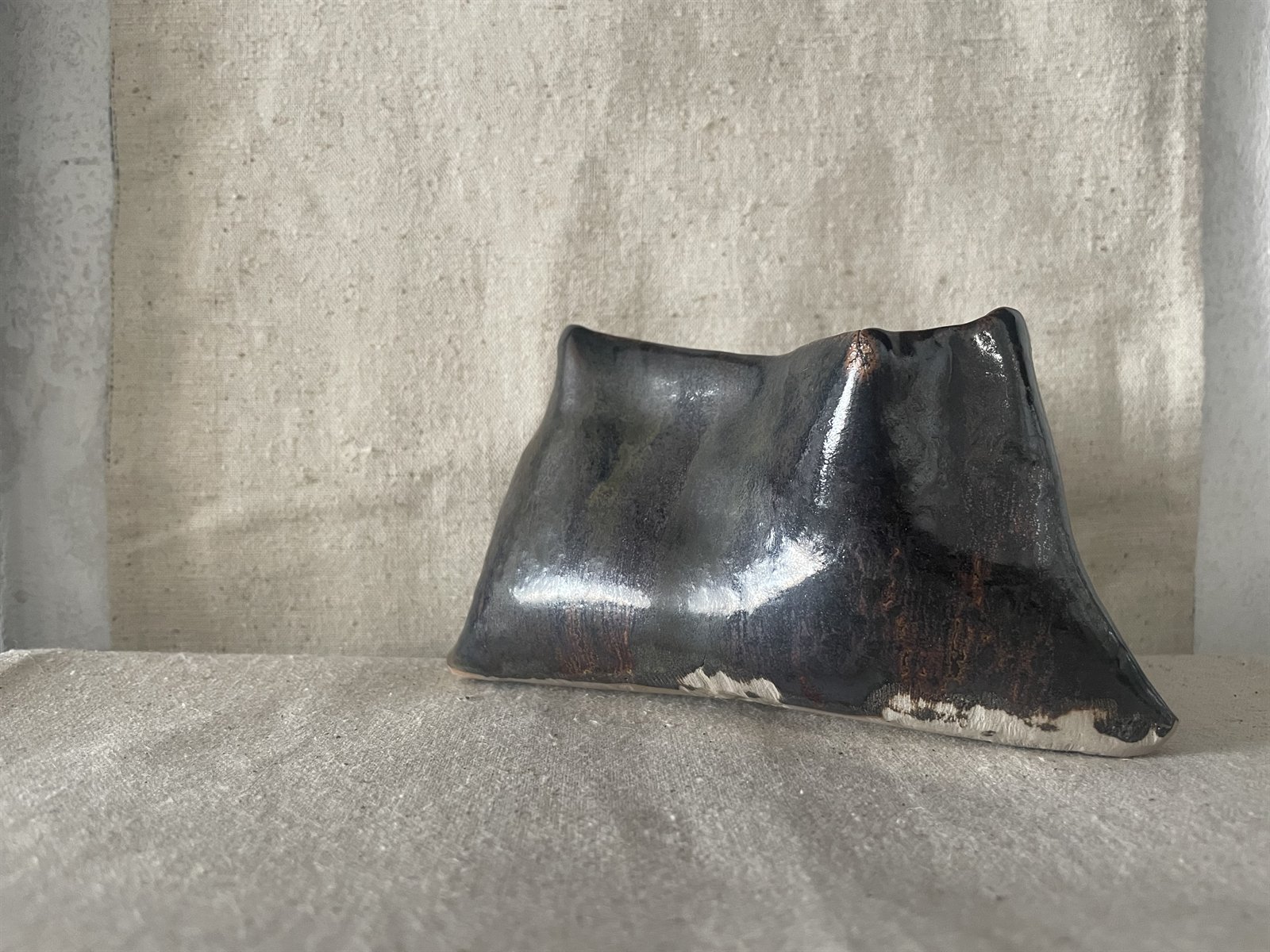 Flared foot bowl with mottled charcoal and iron slip