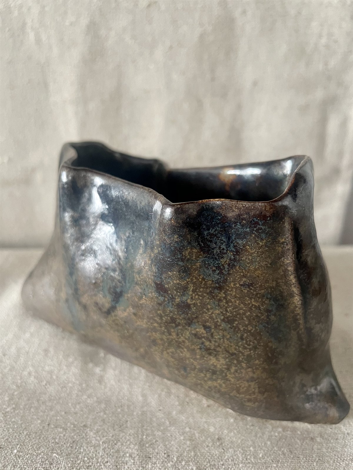 Vertical profile of thrown ceramic cup with tactile exterior ridges