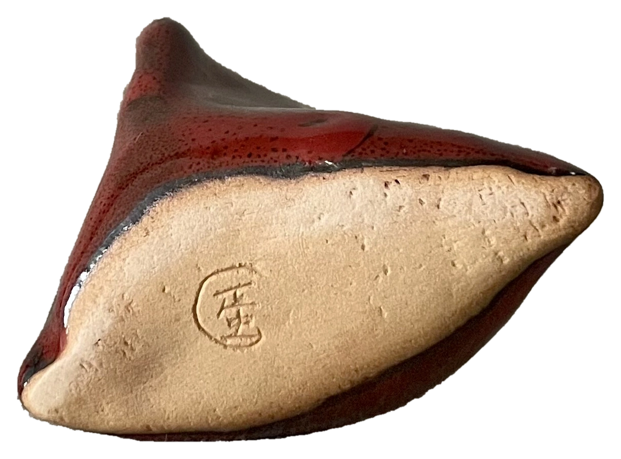Red glazed sculptural ceramic form shown from beneath