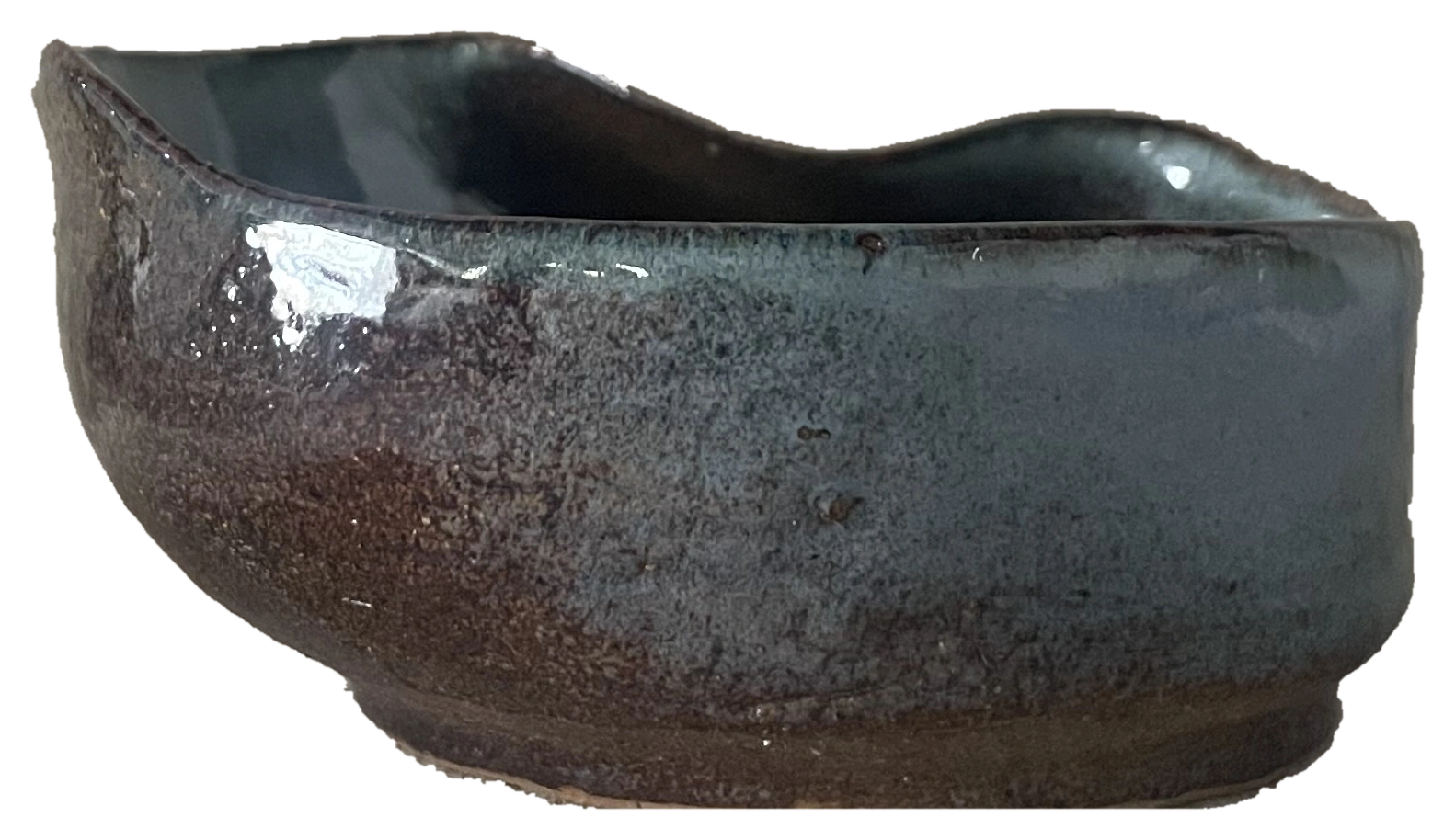 Small dark oval ceramic vessel