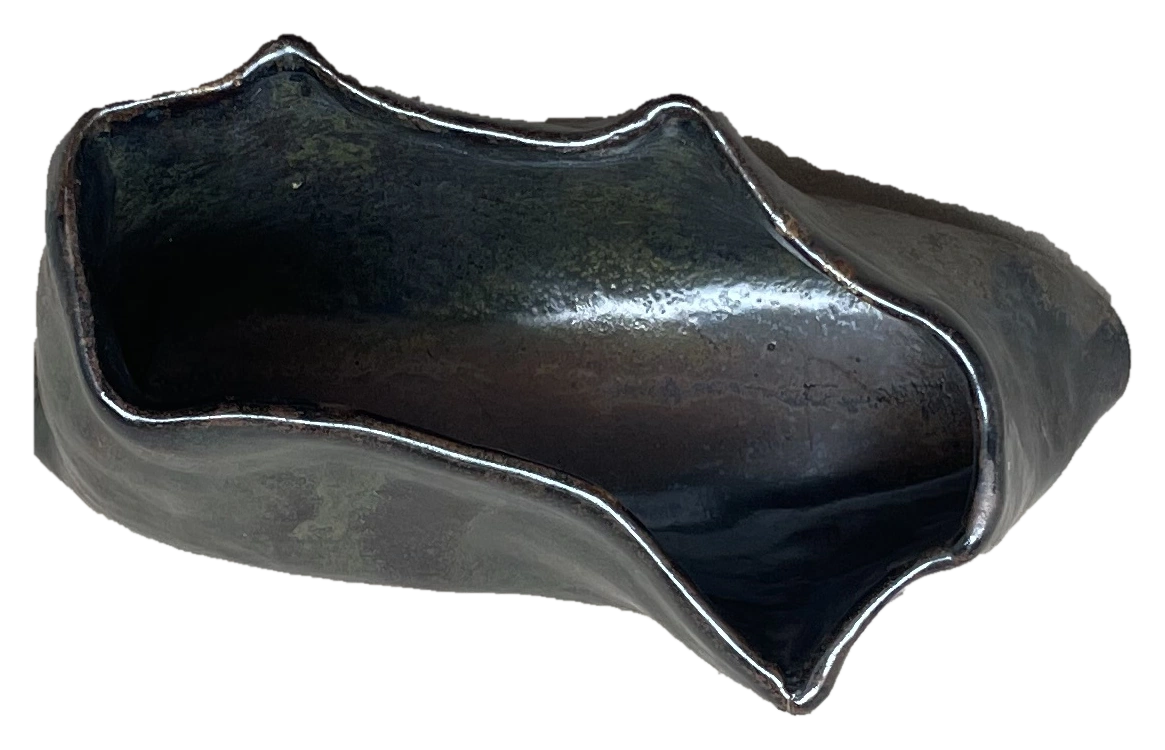 Small black folded ceramic vessel viewed from above