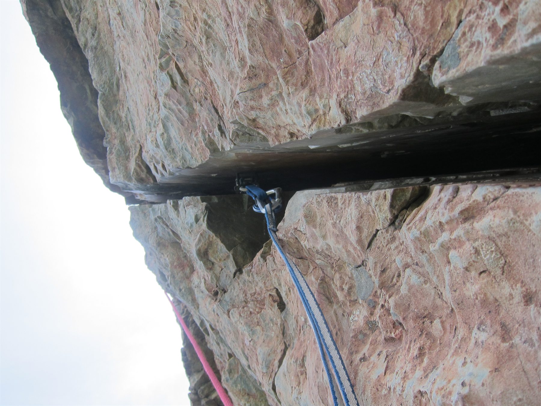 Trad gear placement inside rock fissure